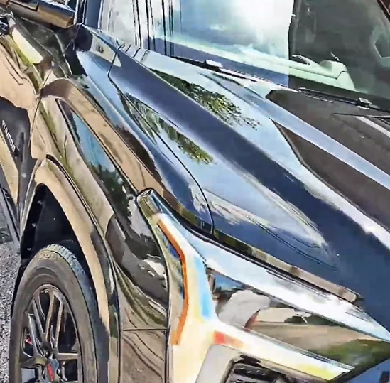 Glossy black SUV after exterior hand wash and detail
