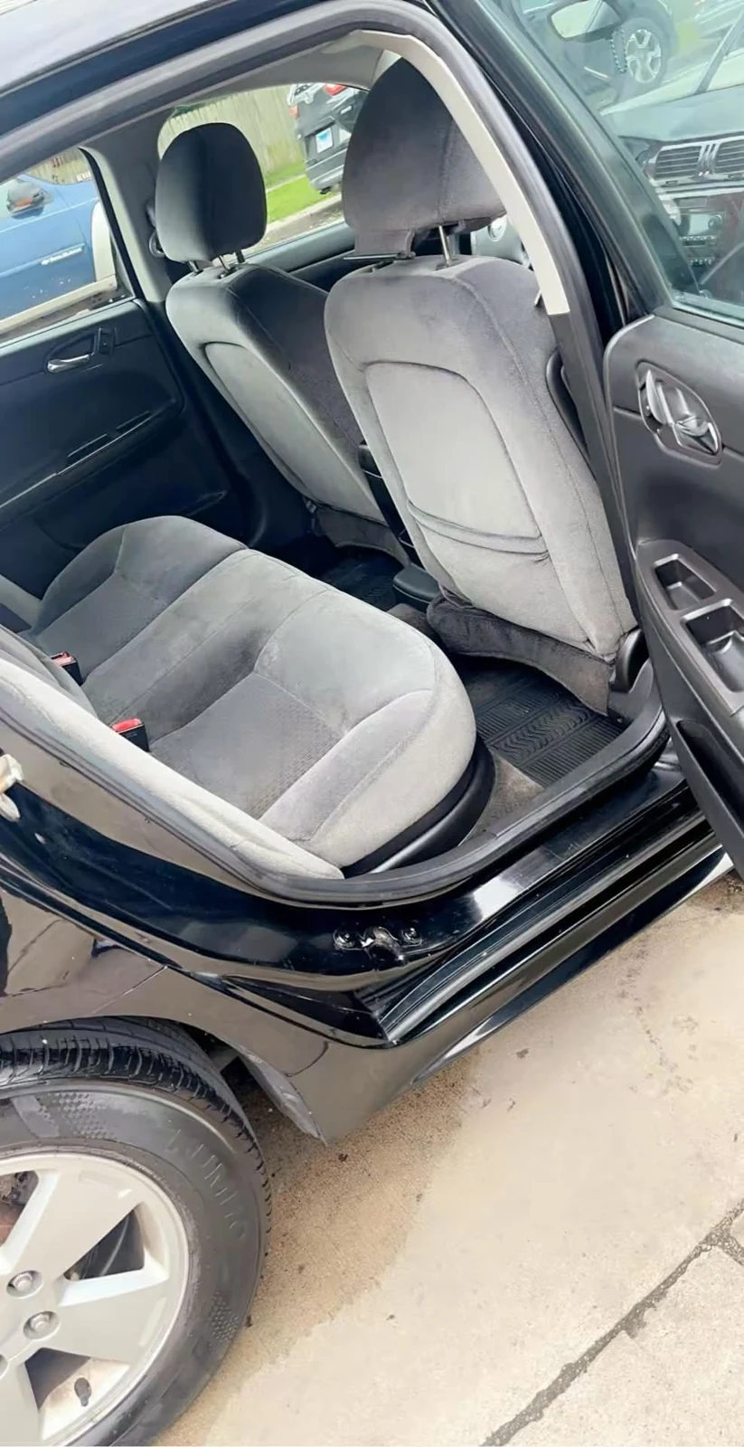 Cleaned rear seating area in a black sedan after interior detail work
