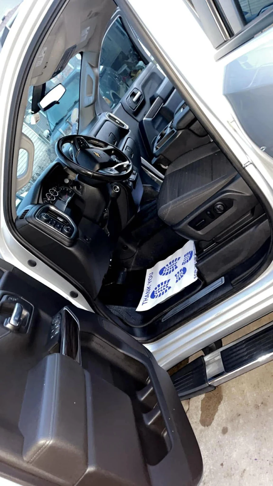 Driver seat area after interior cleanup on a silver pickup