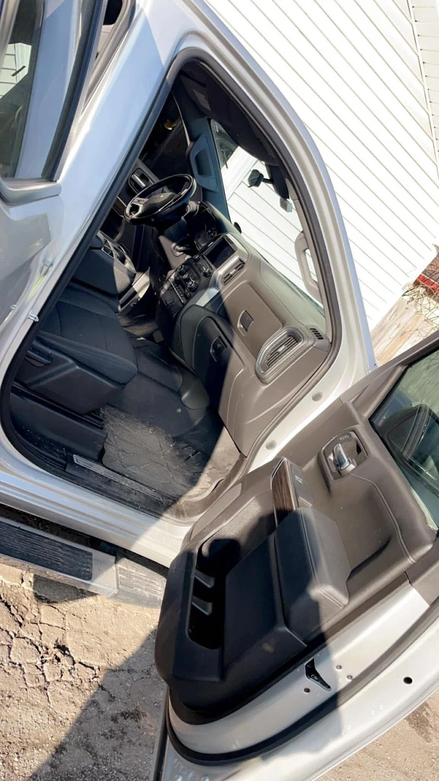 Passenger seat area before interior cleanup on a silver pickup