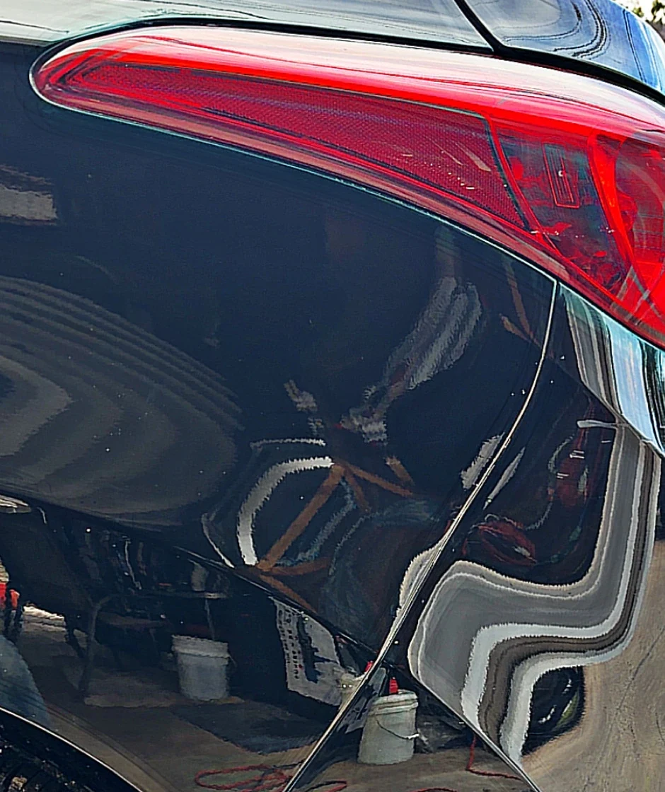 Rear quarter panel after cleanup with a much glossier black finish